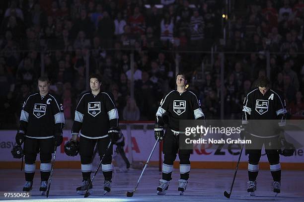 Dustin Brown, Drew Doughty, Ryan Smyth and Anze Kopitar of the Los Angeles Kings stand on the ice during the singing of the National Anthem prior to...