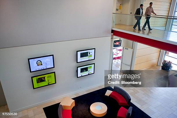 Employees walk inside Google Inc.'s YouTube office in San Bruno, California, U.S., on Thursday, March 4, 2010. The company's YouTube.com website...