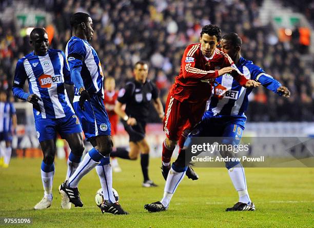 Maxi Rodriguez of Liverpool battles for the ball with Titus Bramble of Wigan during the Barclays Premier League match between Wigan Athletic and...