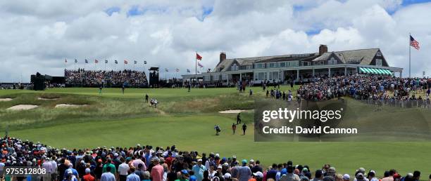 Dustin Johnson, Tiger Woods and Justin Thomas of the United States walk to the green on the ninth hole in front of huge galleries during the second...