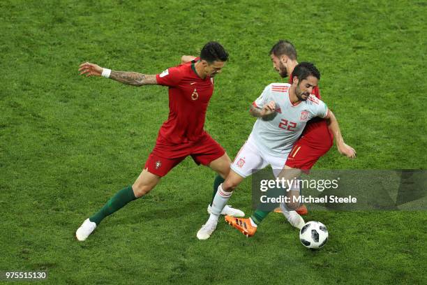 Isco of Spain is tackled by Bernardo Silva of Portugal and Jose Fonte of Portugal during the 2018 FIFA World Cup Russia group B match between...