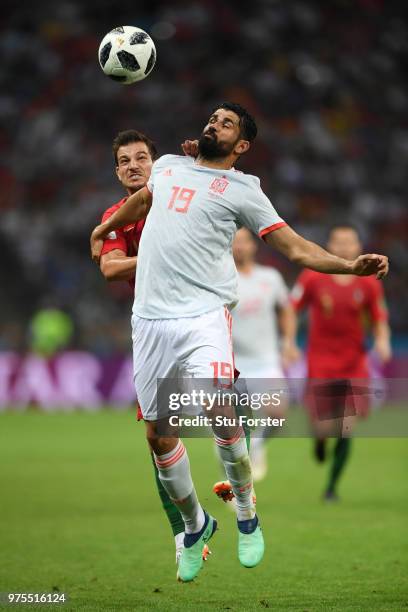 Diego Costa of Spain is challenged by Cedric of Portugal during the 2018 FIFA World Cup Russia group B match between Portugal and Spain at Fisht...