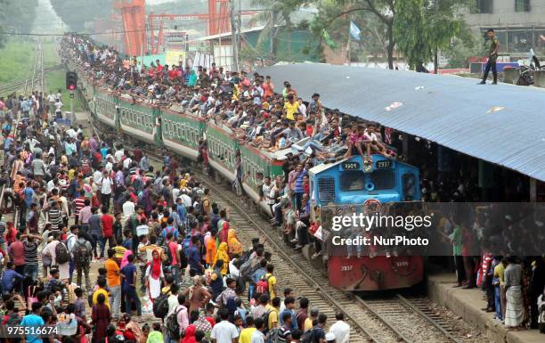 Roofs of trains too get crammed as they reach airport station in Dhaka on Friday, 15 June 2018. People continue to streaming out of the capital on...