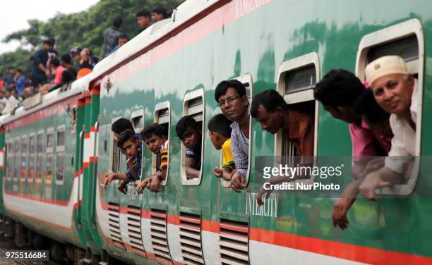 Roofs of trains too get crammed as they reach airport station in Dhaka on Friday, 15 June 2018. People continue to streaming out of the capital on...