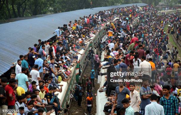 Roofs of trains too get crammed as they reach airport station in Dhaka on Friday, 15 June 2018. People continue to streaming out of the capital on...