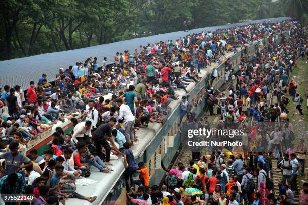 Roofs of trains too get crammed as they reach airport station in Dhaka on Friday, 15 June 2018. People continue to streaming out of the capital on...