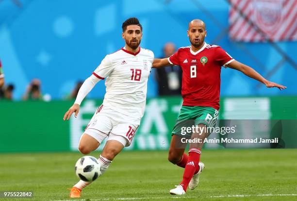 Alireza Jahanbakhsh of Iran and Karim El Ahmadi in action during the 2018 FIFA World Cup Russia group B match between Morocco and Iran at Saint...