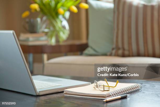 laptop on coffee table - chesterfield sofa stock pictures, royalty-free photos & images