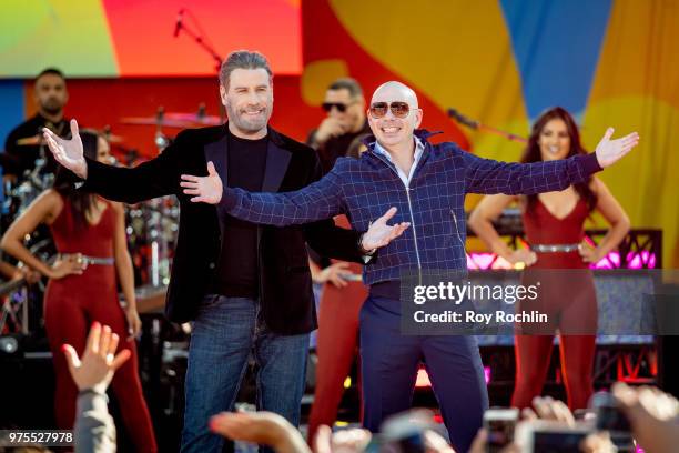 Actor John Travolta on stage as Singer Pitbull Performs on ABC's "Good Morning America" at SummerStage at Rumsey Playfield, Central Park on June 15,...