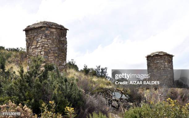 Picture of two restored pre-Inca funerary towers known as chullpas, erected at the Qala Uta archaeological site near Quehuaya, on the slopes of the...