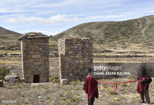 Two restored pre-Inca funerary towers known as chullpas, are seen at the Qala Uta archaeological site near Quehuaya, on the slopes of the hills...