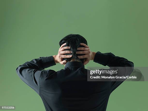 young man with hands behind head - not listening stock pictures, royalty-free photos & images