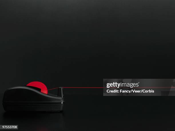 red tape on tape dispenser - tape dispenser photos et images de collection