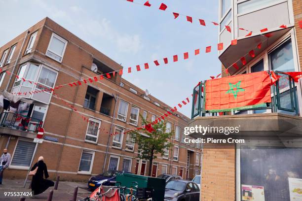 Moroccan flags decorate a street in Schilderswijk, a neighborhood in The Hague where the Dutch-Moroccan community are supporting the Moroccan...