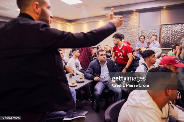 Inhabitants of Schilderswijk, a neighborhood in The Hague with a Dutch-Moroccan community watch the Moroccan national footbal team as they play Iran...