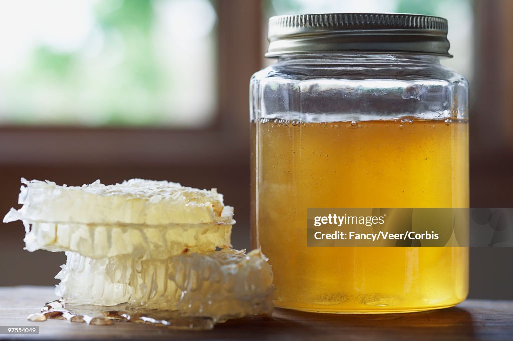 Honeycombs and a jar of honey