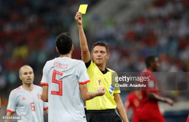 Referee of the match Gianluca Rocchi shows yellow card to Sergio Busquets of Spain during the 2018 FIFA World Cup Russia Group B match between...