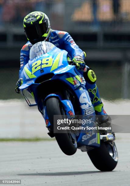 Andrea Iannone of Italy and Team Suzuki Ecstar lifts the front wheel during free practice for the MotoGP of Catalunya at Circuit de Catalunya on June...