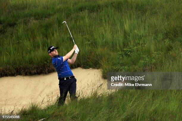 Branden Grace of South Africa plays a shot from a bunker on the tenth hole during the second round of the 2018 U.S. Open at Shinnecock Hills Golf...