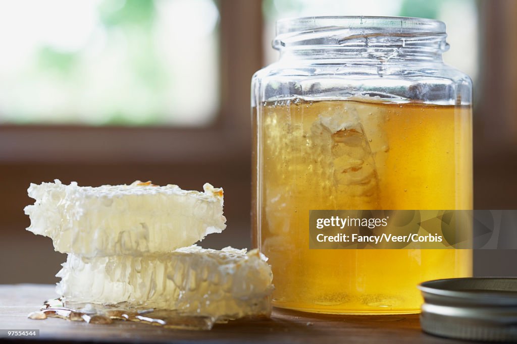 Honeycombs and a jar of honey