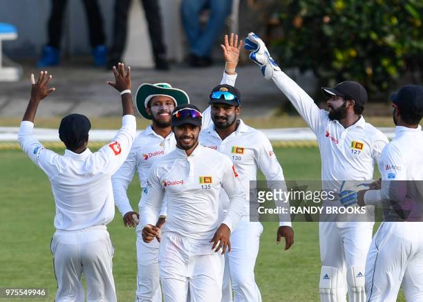 Kusal Mendis , Dhananjaya de Silva , Kusal Perera and Niroshan Dickwella of Sri Lanka celebrate the dismissal of Kieran Powell of West Indies during...