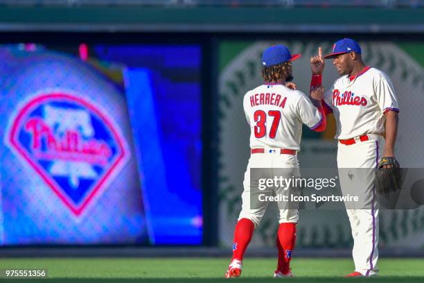 Philadelphia Phillies center fielder Odubel Herrera and Philadelphia Phillies first baseman Carlos Santana chat during warm ups before the MLB game...