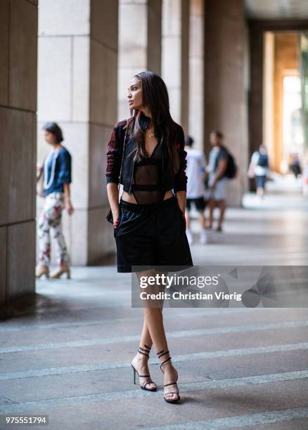 Model Joan Smalls wearing sheer body, jacket, shorts is seen outside Alberta Ferretti during Milan Men's Fashion Week Spring/Summer 2019 on June 15,...