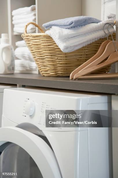 laundry basket on washing machine - utility room stock pictures, royalty-free photos & images