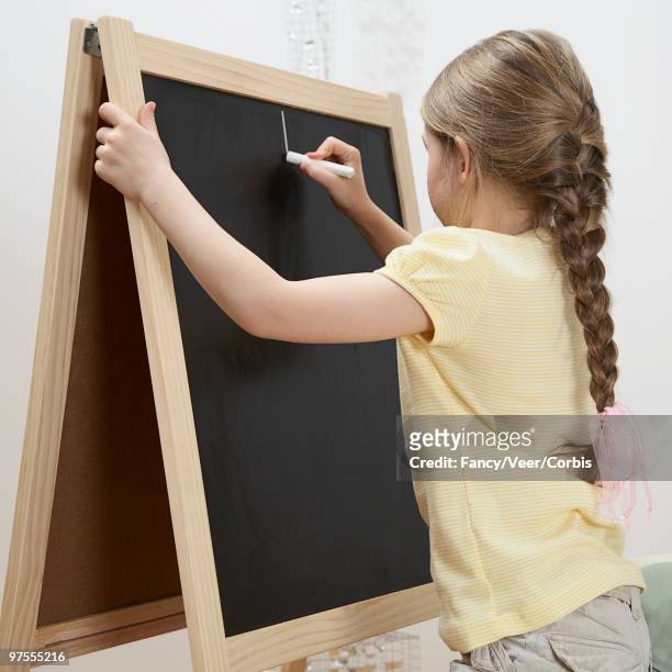 girl drawing on chalkboard - children only braided ponytail stock pictures, royalty-free photos & images
