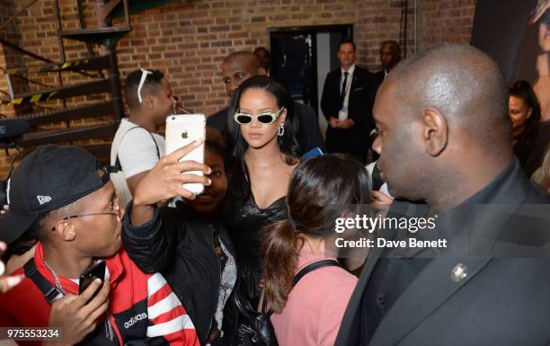Rihanna poses with fans at the Savage X Fenty London pop-up shop in Shoreditch on June 15, 2018 in London, England.