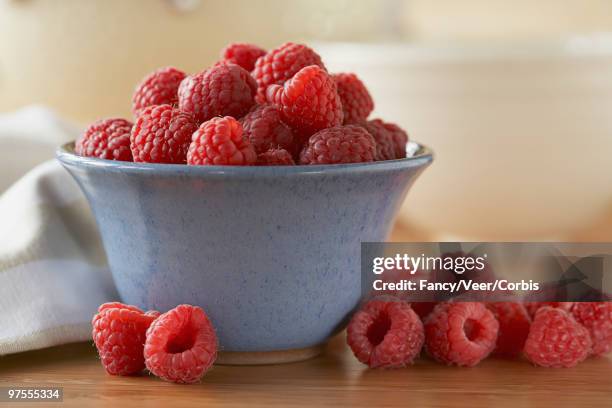 bowl of raspberries - overflowed stock pictures, royalty-free photos & images