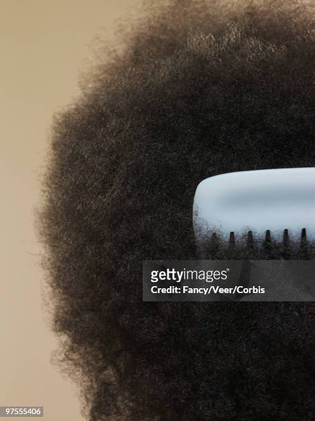 close-up of afro with comb - kinky stock-fotos und bilder