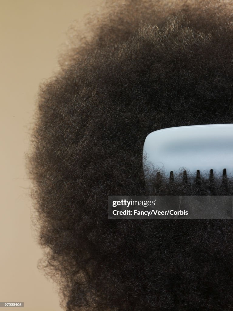 Close-up of afro with comb