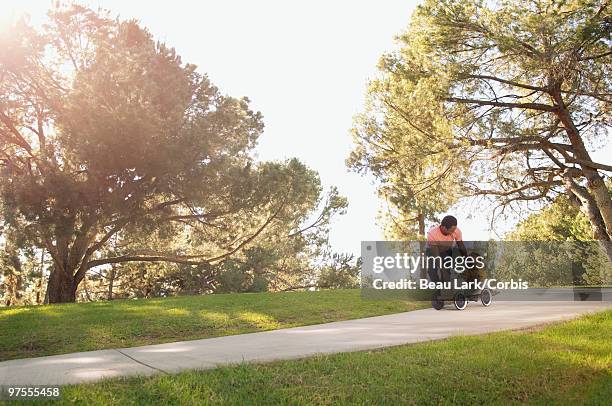 father pushing son in soapbox car - soapbox cart foto e immagini stock