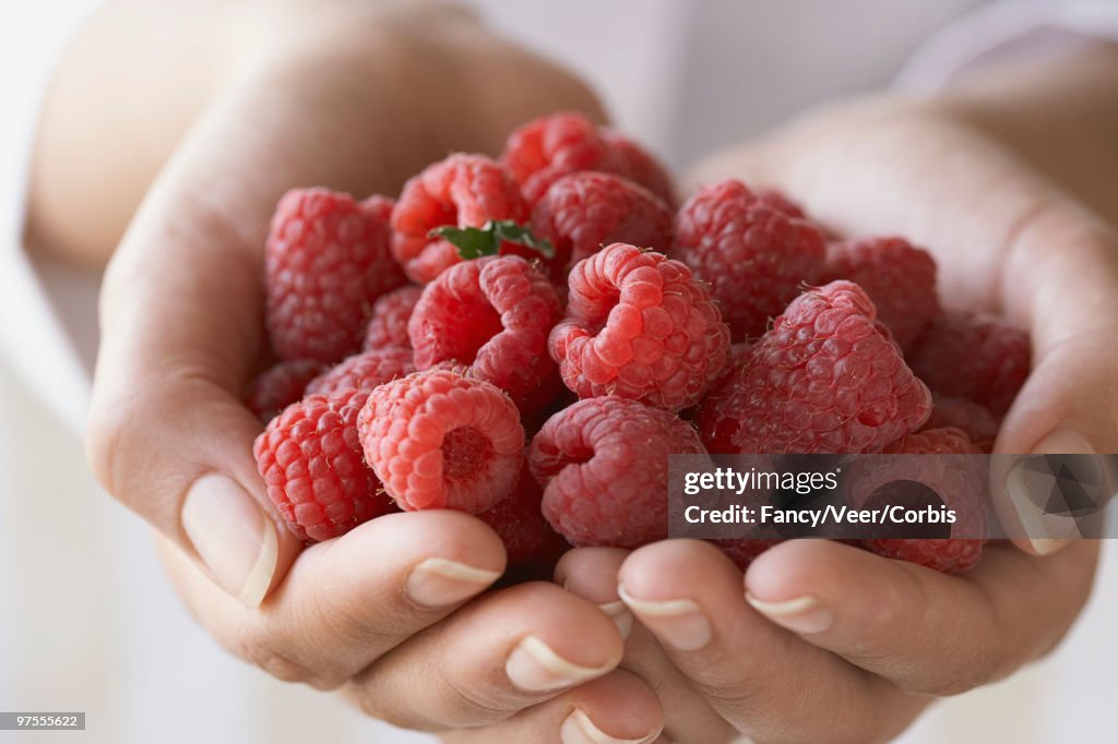 Woman Holding Raspberry Woman Holding Handful Of Raspberries High-Res Stock Photo - Getty Images