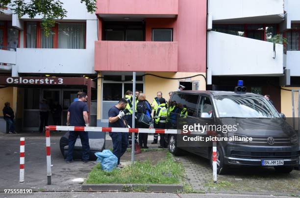 June 2018, Germany, Cologne: Police officers and employees of the Robert Koch Institute standing before the residential complex Osloerstr. 3 in...