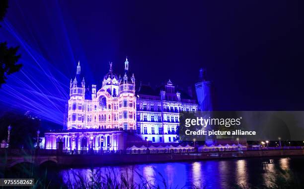 June 2018, Germany, Schwerin: Schwerin Palace shining during a rehearsal of the light show for the Palace Festival taking place between 15 and 17...