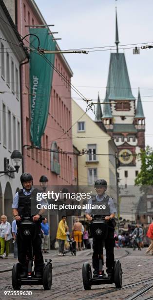 June 2018, Germany, Freiburg: Police officers Matthias Engler and Janka Schmidt standing on Segways in downtown Freiburg. The Police in Freiburg will...