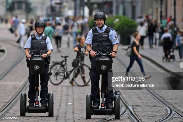 June 2018, Germany, Freiburg: Police officers Matthias Engler and Janka Schmidt standing on Segways in downtown Freiburg. The Police in Freiburg will...