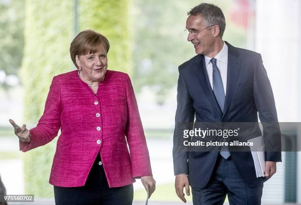 June 2018, Germany, Berlin: German Chancellor Angela Merkel of the Christian Democratic Union and NATO secretary general Jens Stoltenberg give a...