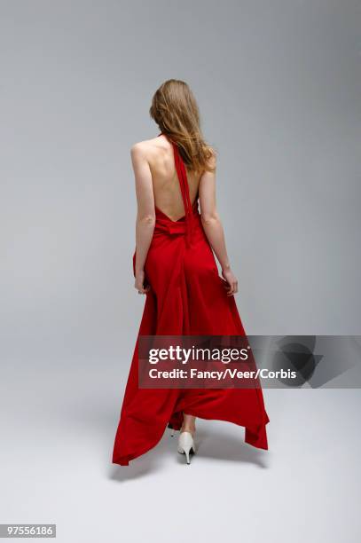 fashion model in red dress and white shoes - backless dress stock pictures, royalty-free photos & images