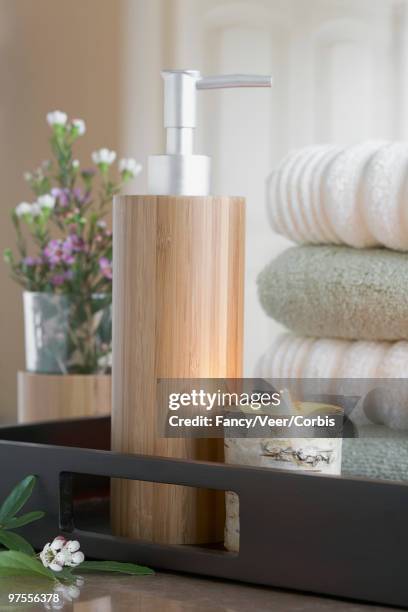 tray with wooden soap dispenser and towels - bathroom closeup stock pictures, royalty-free photos & images