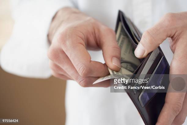 man taking money from wallet - carte bancaire voiture photos et images de collection
