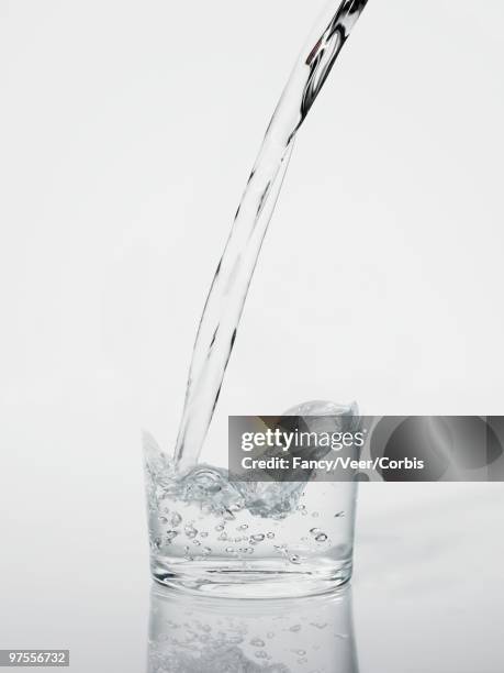 invisible drinking glass filling with water - disappear stockfoto's en -beelden