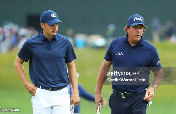 Jordan Spieth of the United States and Phil Mickelson of the United States walk on the 14th green during the second round of the 2018 U.S. Open at...