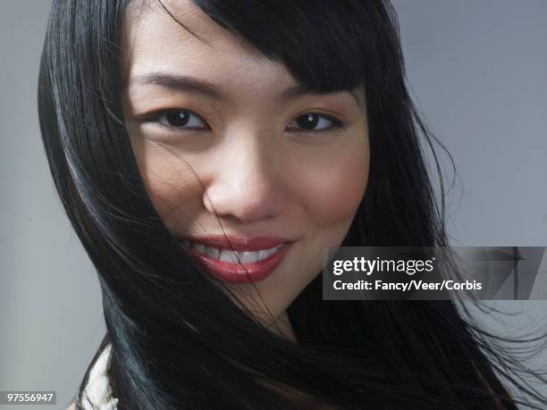 woman looking at camera with long flowing hair - long straight hair stock pictures, royalty-free photos & images