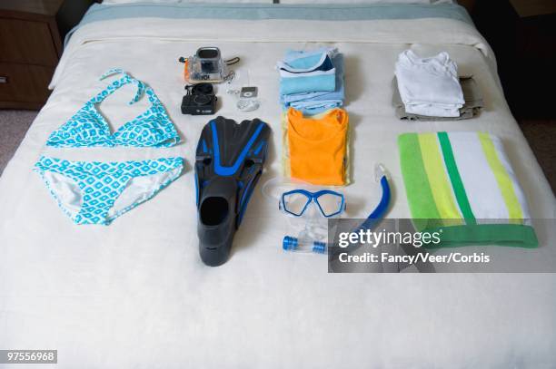 vacation clothes laid out on bed - swimwear singlet stock pictures, royalty-free photos & images