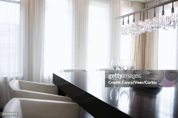 four wine glasses and table settings on dinner table - leaded glass stock-fotos und bilder