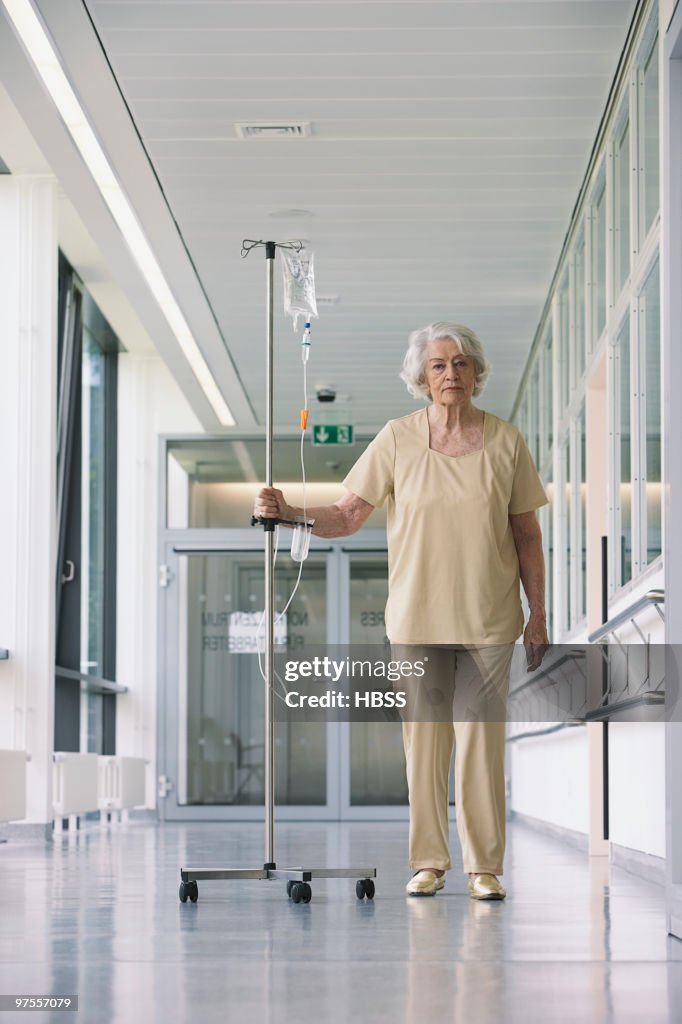 Patient walking in hallway with iv