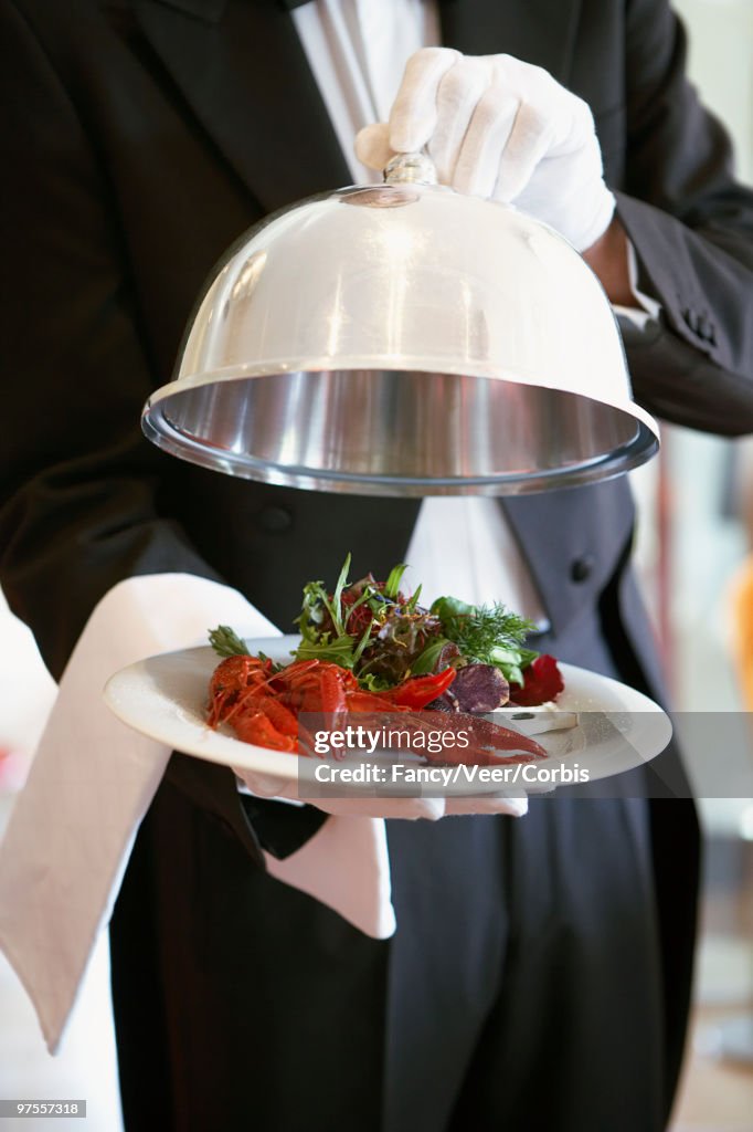 Waiter serving lobster